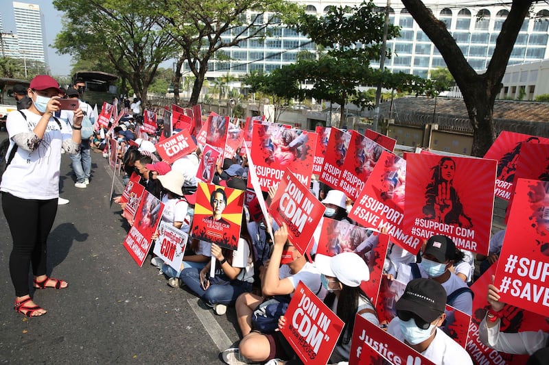 Anti-military junta protesters trying to enlist civil servants to join nationwide demonstrations rally in Myanmar's largest city, Yangon, Feb. 15, 2021.