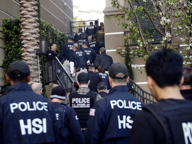 Federal agents raid an apartment complex, March 3, 2015, in Irvine, Calif., to conduct a crackdown on alleged maternity tourism rings.