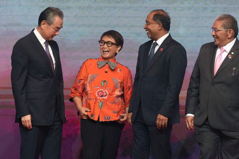 Chinese Communist Party's foreign policy chief Wang Yi shares a light moment with some ASEAN Foreign Ministers during the ASEAN Foreign Ministers' Meeting in Jakarta, Indonesia, July 13, 2023. (Tatan Syuflana/Pool via AP)