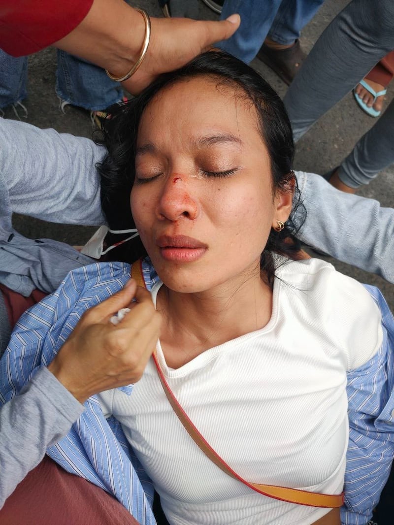 Fellow NagaWorld strikers attempt to revive Sun Sreynich, who says a police officer punched her in the nose and knocked her out. Credit: Citizen journalist