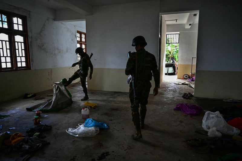 Fighters of Ta'ang National Liberation Army search a building after running over a compound belonging to Myanmar junta military in Shan State, Dec. 12, 2023. (AFP Photo)