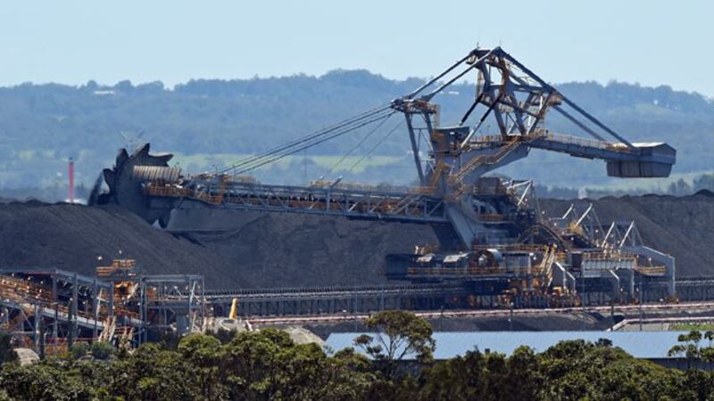 A machine moves coal for export at the Port of Newcastle in the city of Newcastle, New South Wales, Australia, Nov. 18, 2015.