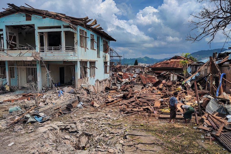 People clean up the debris of destroyed and damaged buildings in the aftermath of bombardments by Myanmar's military in Lashio in Myanmar's northern Shan State on Sept. 24, 2024.