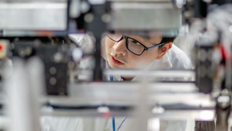 A worker examines equipment at the Guangdong Ruigu Optical Network Communications Co. Ltd., an optical component and transceiver manufacturer in Dongguan, southeast China's Guangdong province, May 7, 2019.