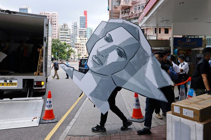 Police remove a cutout of the “Goddess of Democracy” from the June 4th Museum. (Reuters)