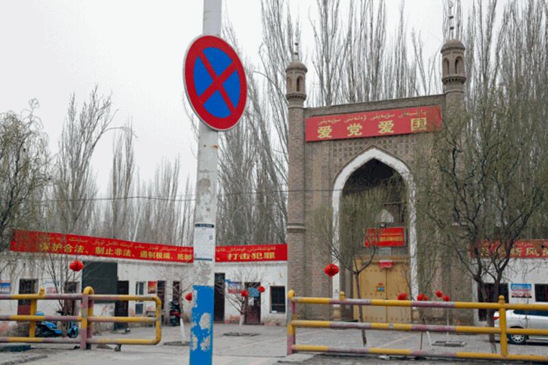 A banner reading 'Love the Party, Love the Country' in the Chinese and Uyghur languages hangs from a mosque near Kashgar Yengisheher county, Kashgar prefecture, in northwestern China's Xinjiang region, March 20, 2021. Credit: Associated Press