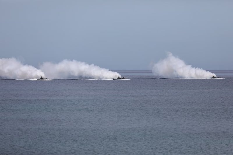 Amphibious assault vehicles carrying Philippine and U.S. soldiers prepare to land on a beach in the Philippines' Zambales province, Oct. 7, 2022.