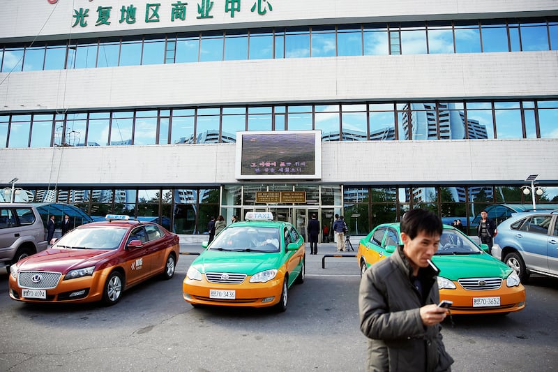 Taxis are parked outside a department store in central Pyongyang, North Korea May 4, 2016.