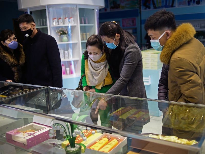 Shoppers look at cosmetics on display at a gift shop of the Pyongyang Cosmetics Factory, North Korea, on March 8, 2020.