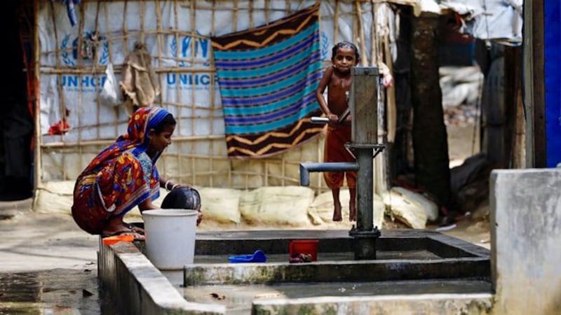 Hindu Rohingya refugees from western Myanmar's Rakhine pump water in a refugee camp in southeastern Bangladesh's Cox's Bazar district, Nov. 13, 2018.