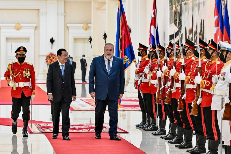 Hun Sen and Cuban Prime Minister Manuel Marrero Cruz inspect an honor guard during a meeting at the Peace Palace in Phnom Penh. Credit: AFP/Cambodia's government cabinet/Kok Ky