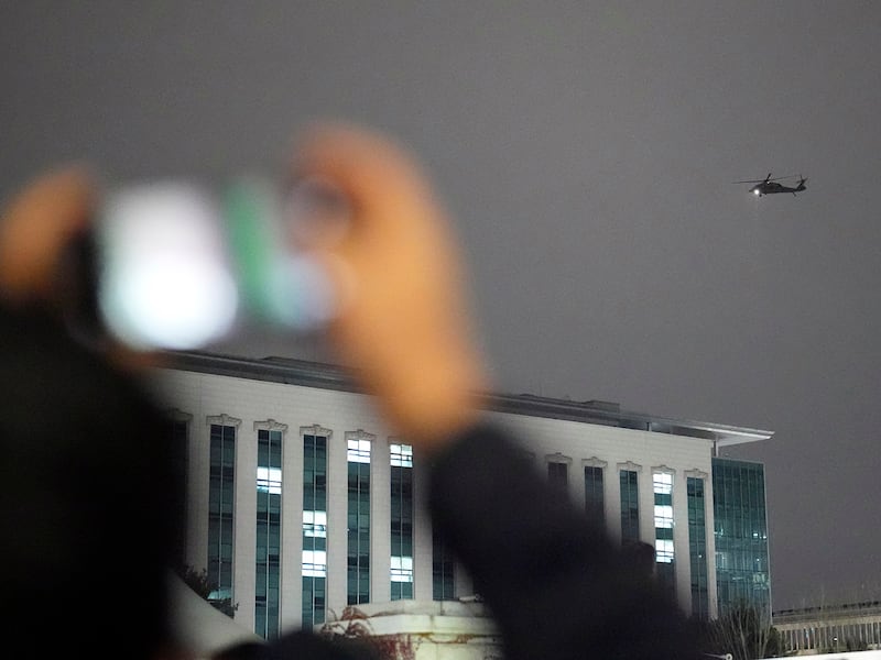 A helicopter flies over the National Assembly in Seoul, Dec. 4, 2024.