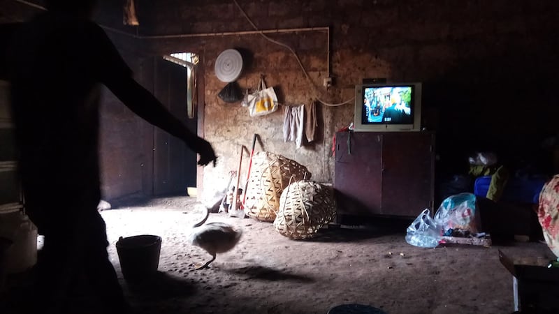 The traditional earthen house of the Yi people with a firepit that serves as a kitchen and a meeting place.