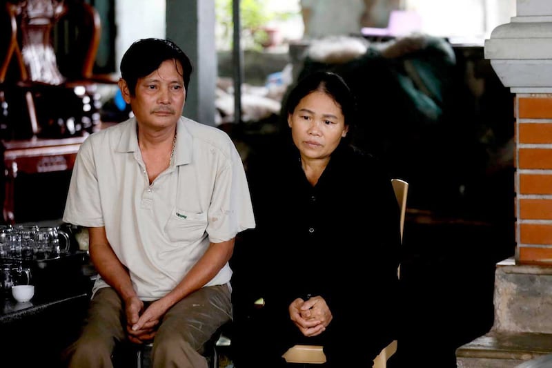 Hoang Lanh, left, and Hoang Thi Ai, parents of lorry victim Hoang Van Tiep, await the arrival of their son's coffin at their home in the Dien Chau District, Nghe An Province, Vietnam, on Nov. 27, 2019. (Associated Press)