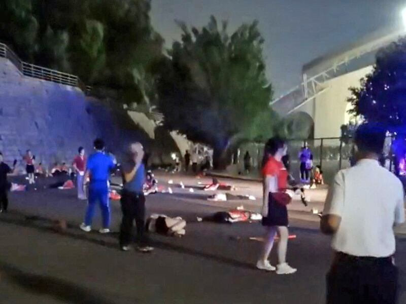 Injured people lie on the road after a car rammed into them outside a sports center in Zuhai, China, Nov. 11, 2024.