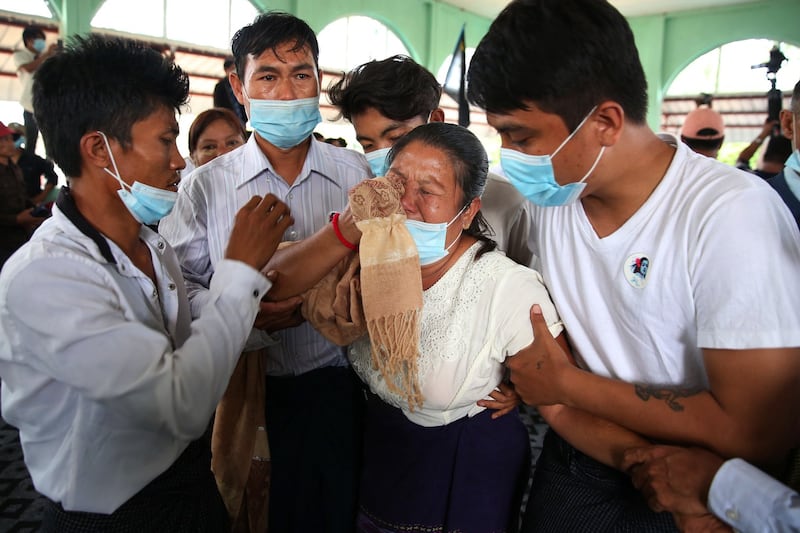 The mother of Mya Thwe Thwe Khine, the first protester to die in demonstrations against the Myanmar military coup, mourns her daughter in Naypyidaw, Feb. 21, 2021.