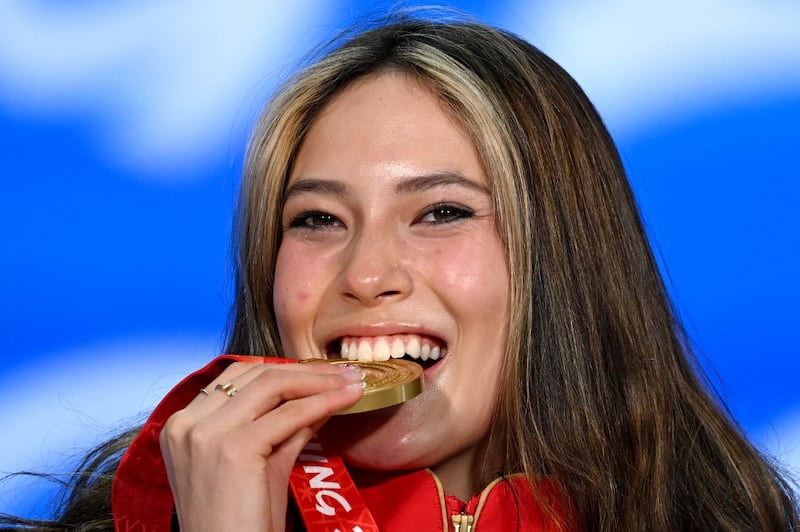 Gold medalist Eileen Gu celebrates on the podium during the freestyle skiing women's freeski big air victory ceremony at the Beijing Medals Plaza in Beijing, Feb. 8, 2022.