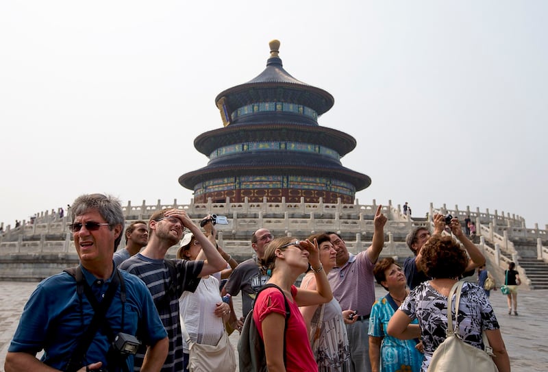 A group of foreign tourists visit the Temple of Heaven in Beijing, July 31, 2013. (Andy Wong/AP)