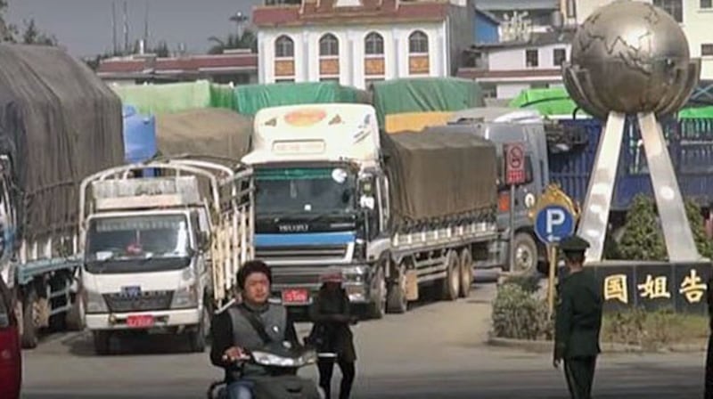 Trucks line up at a border crossing between southwest China's Yunnan province and Myanmar's northern Shan state, April 10, 2020.