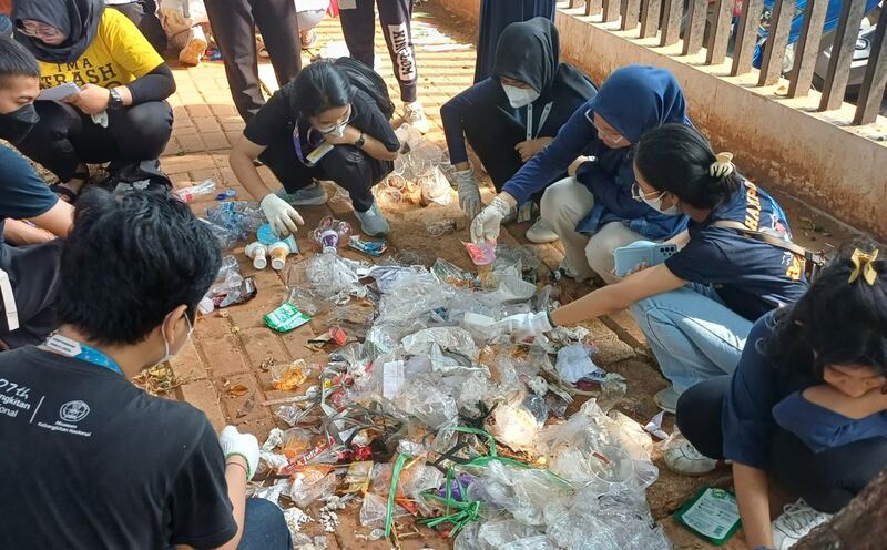 This undated November 2023 photo shows volunteers from Indonesian community organization Trash Hero sorting through discarded plastic in Lapangan Banteng, Jakarta