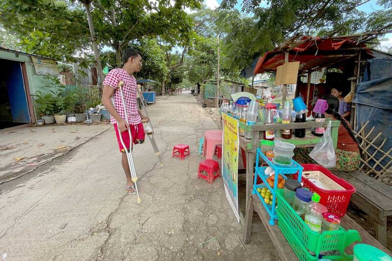 Ko Phyo looks to buy a toy for his son at a shop near his home. (REUTERS)