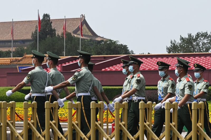 Paramilitary police officers patrol Tiananmen Square a day before an event marking the 100th anniversary of the founding of the Communist Party of China, in Beijing, June 30, 2021. Credit: AFP