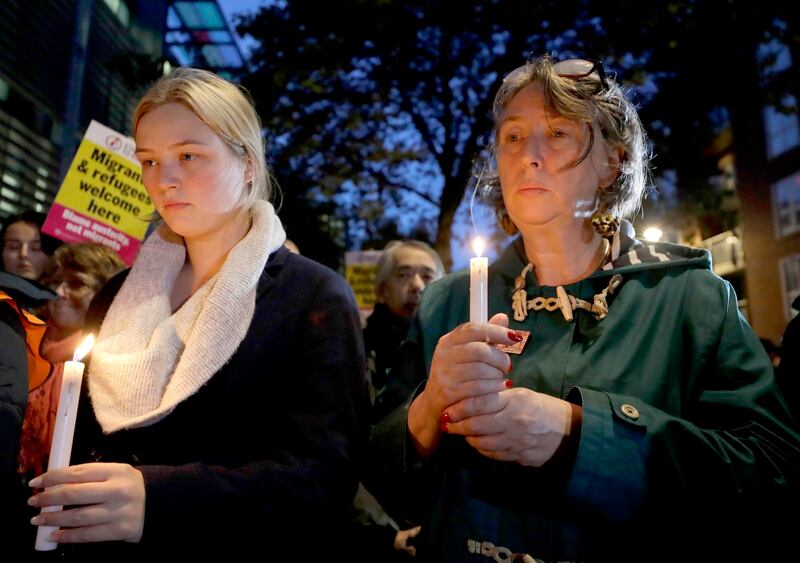 Demonstrators hold banners and candles during a vigil for the 39 Vietnamese lorry victims, outside the Home Office in London, in 2019. Credit: AP