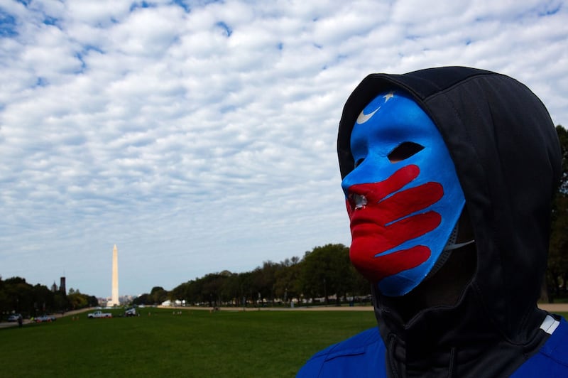 A Uyghur protester participates in "Resist CCP: Global Day of Action" in front of the Capitol Reflecting Pool in Washington D.C., Oct. 1, 2020. 