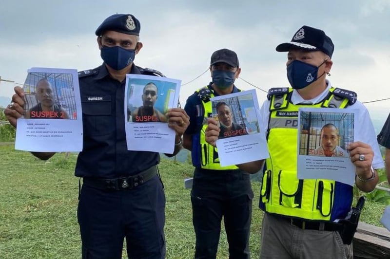 Kedah Police Chief Wan Hassan Wan Ahmad (right) and colleagues shows images of four Rohingya men accused of instigating a riot at an immigration depot two days earlier, Bandar Baharu, Kedah, April 22, 2022. Two of the four have been captured. Credit: BenarNews.