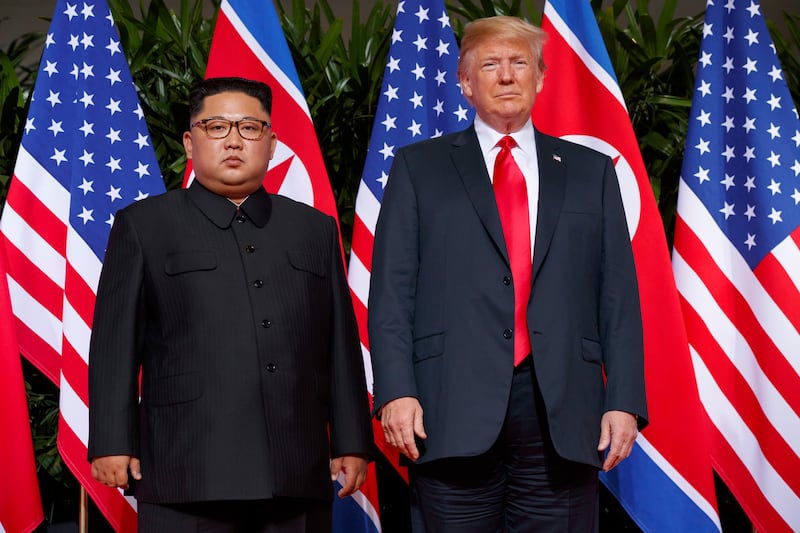 FILE - In this June. 12, 2018, file photo, U.S. President Donald Trump, right, meets with North Korean leader Kim Jong Un on Sentosa Island, in Singapore. North Korea says it will never unilaterally give up its nuclear weapons unless the United States removes its nuclear threat first. The statement carried by the official Korean Central News Agency on Thursday, Dec. 20, 2018,  comes amid a deadlock in nuclear negotiations between the United States and North Korea. It raises further doubts on whether leader Kim Jong Un will ever relinquish an arsenal he may see as his greatest guarantee of survival. (AP Photo/Evan Vucci, File)