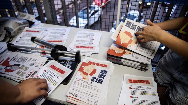 Pro-democracy Demosisto Party members distribute flyers in Hong Kong against China's controversial national security law for the former British colony that was submitted to China's rubber-stamp in Beijing, May 22, 2020.