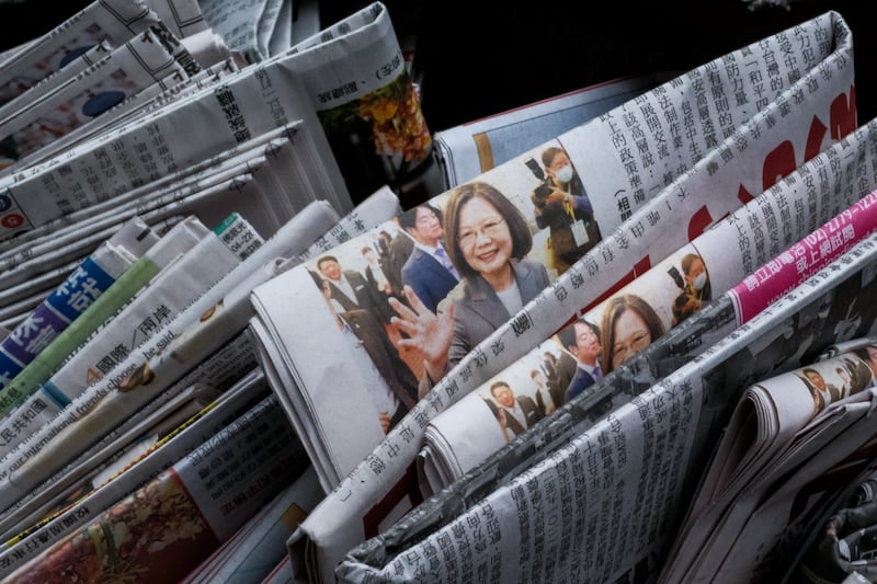 A photo illustration shows newspapers being delivered in the sidebag of a motorcycle with a front page photograph of Taiwan’s former president Tsai Ing-wen.