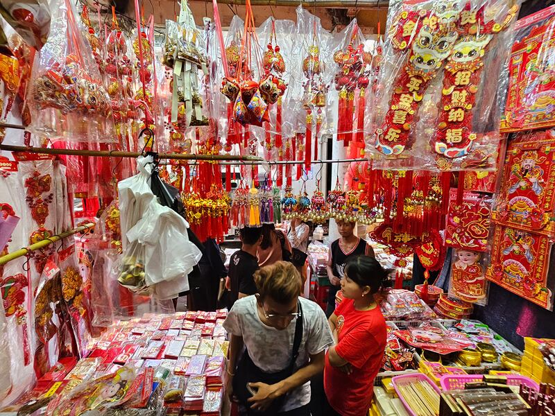 Customers browse in a shop at a New Year’s market in Yangon’s Chinatown, Jan. 21, 2025.