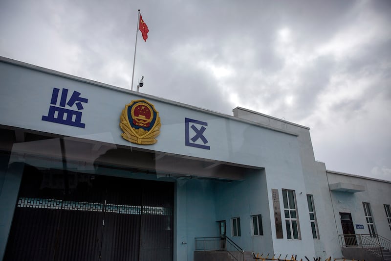 A Chinese national flag flies over a vehicle entrance to the inmate detention area at the Urumqi No. 3 Detention Center in Dabancheng, western China's Xinjiang Uyghur Autonomous Region, April 23, 2021.