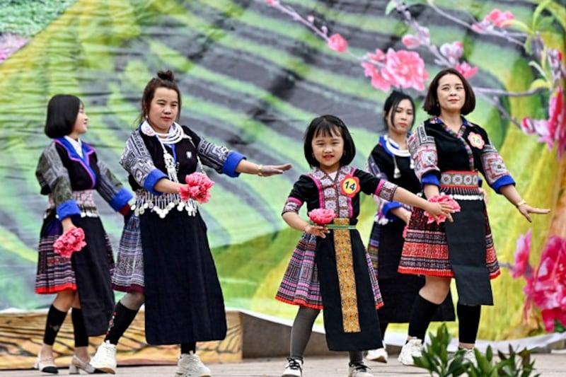 Ethnic Hmong girls wearing traditional outfits dance to celebrate the Vietnamese Lunar New Year, or Tet, in northern Vietnam's Yen Bai province, Feb. 12, 2024. (Nhac Nguyen/AFP)