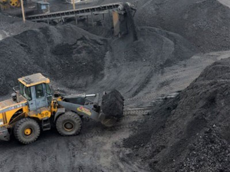 A front-end loader piles up coal at a coal yard in Huaibei, eastern China's Anhui province, Nov. 17, 2016.