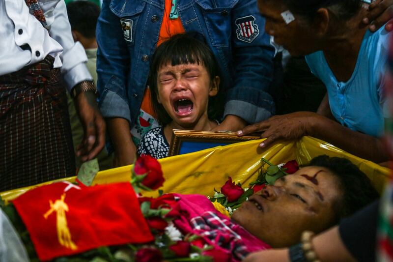 The daughter of Zwee Htet Soe, a protester who died during a demonstration against the military coup, cries during her father's funeral in Yangon, March 5, 2021. AFP