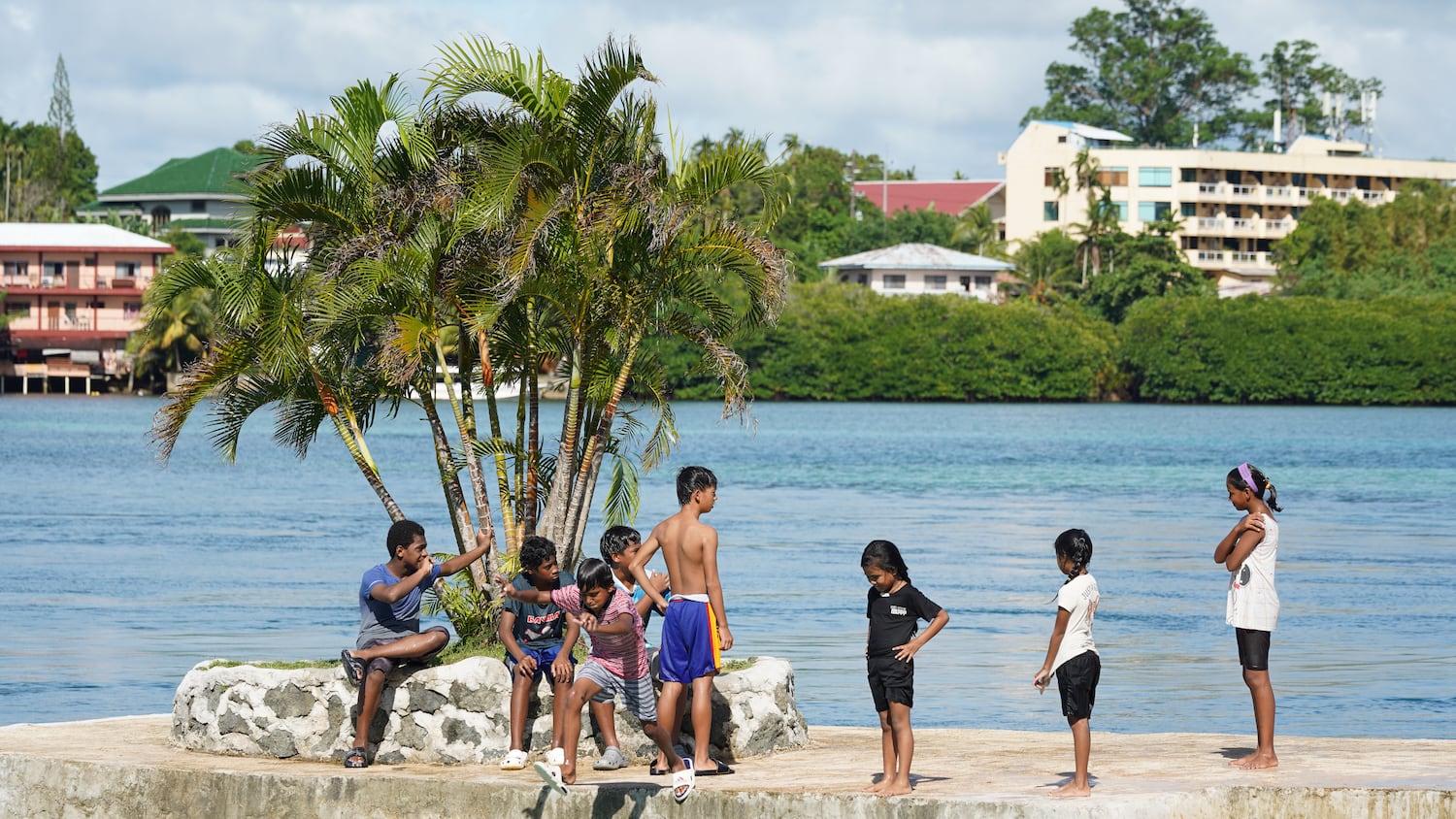 A group of children play near the ocean in Koror, Nov. 29, 2024.