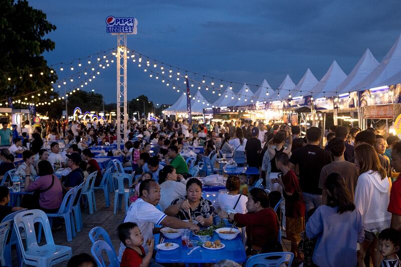 People eat at a night market in Vientiane, Oct. 28, 2023. (Jack Taylor/AFP)