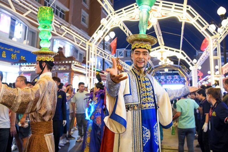 Actors perform at the Grand Bazaar, a popular tourist destination in Urumqi, capital of northwestern China's Xinjiang region, Aug. 28, 2023. (Wang Fei/Xinhua via Getty Images)