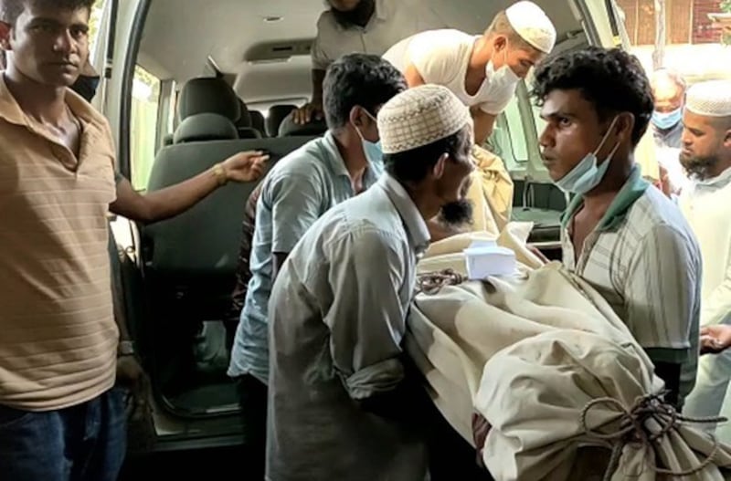 Hospital workers and volunteers unload the body of a Rohingya who was killed in an attack at a madrassa in a local refugee camp, for an autopsy at a hospital in Cox's Bazar, Bangladesh, Oct. 22, 2021. Credit: BenarNews