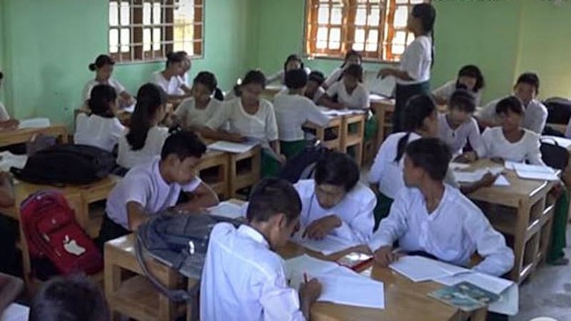 Myanmar students complete a writing assignment at a school in Sittwe, western Myanmar's Rakhine state, in 2019.