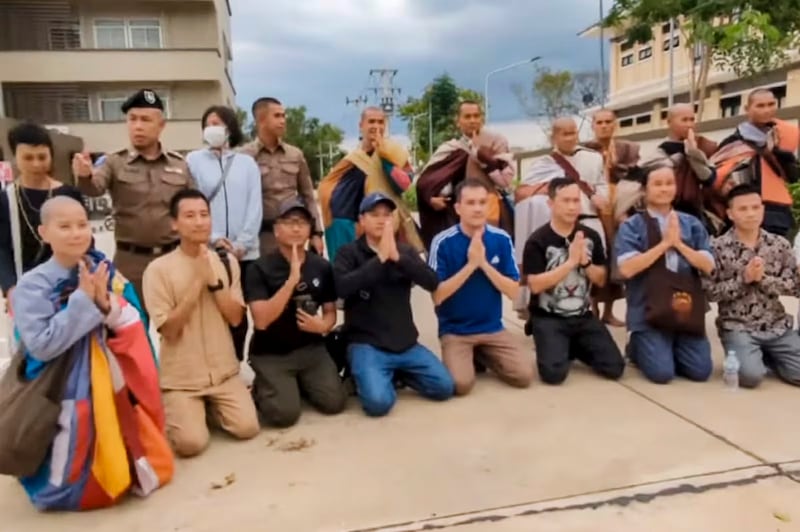 Thich Minh Tue, second from right in back row, poses for a photo with Thai police on Feb. 24, 2025, outside the Phichit Provincial Immigration Office.