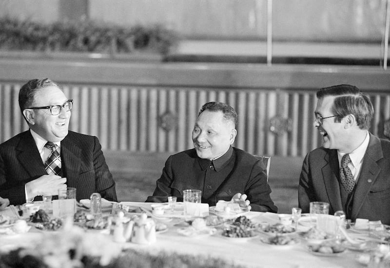 U.S. Secretary of State Henry Kissinger [left], Chinese Deputy Prime Minister Deng Xiaoping and White House Chief of Staff Donald Rumsfeld admire the banquet site at the Great Hall of the People in Beijing, Nov. 25, 1974. (AP)