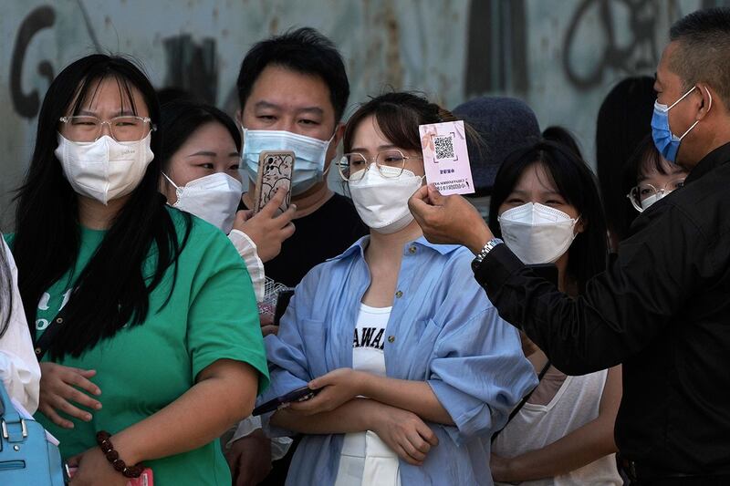 2022 年 9 月 8 日，在北京举行中国时装周期间，民众扫描二维码以出示健康码进入。（美联社）