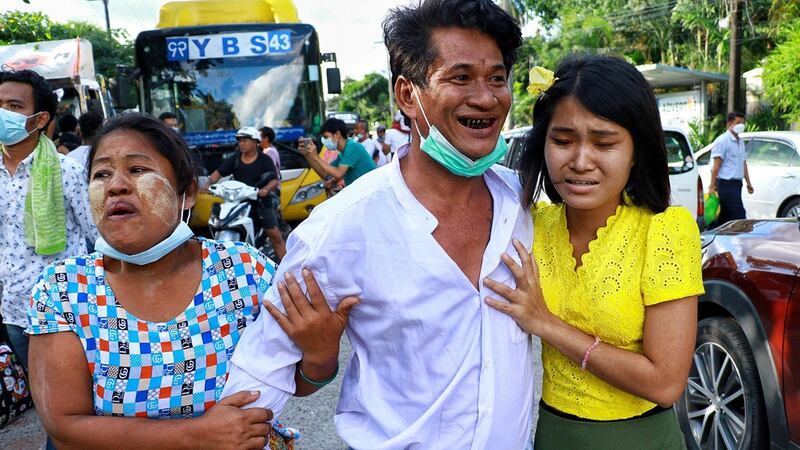 A man (C) reunites with his family after his release from Insein Prison in Yangon, Oct. 19, 2021. MPA Photo