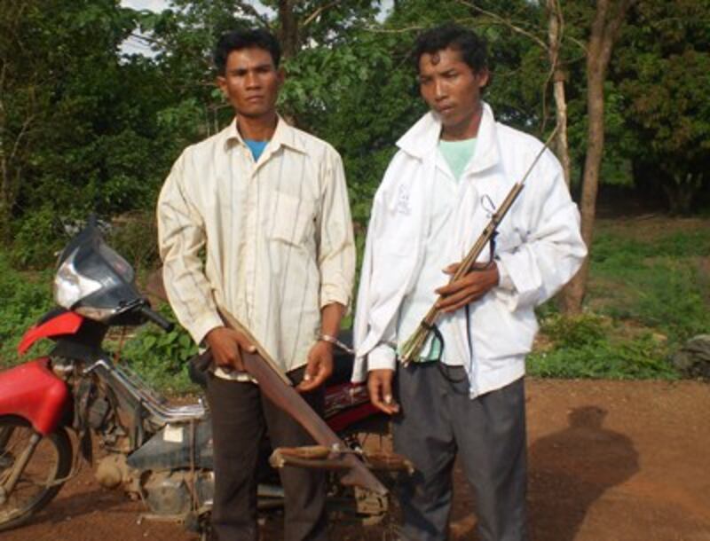 Residents of Broma village hold homemade weapons in an undated photo. Credit: RFA