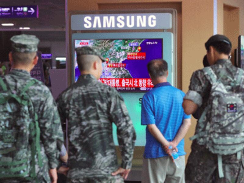 South Korean soldiers watch a television broadcast reporting on North Korea's latest nuclear test, at a railway station in Seoul, Sept. 9, 2016. 