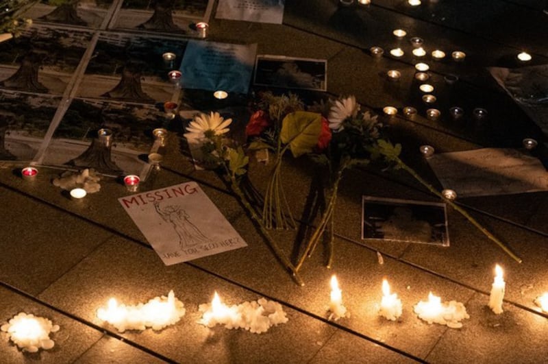 Flowers, candles and a portrait of the “Goddess of Democracy” statue are placed at its site after it was removed from the Chinese University of Hong Kong , Dec. 24, 2021. Credit: AFP