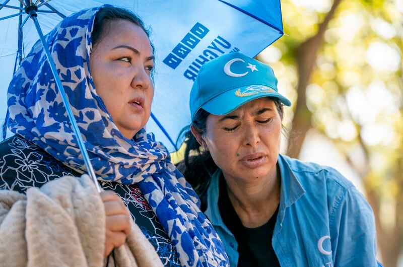 Uyghur camp survivor Zumret Dawut, left comforts Tursunay Ziyawudin during a hunger strike 48 hours into their hunger strike in front of the White House in Washington, DC, Sept. 21, 2022. A small group of Uyghurs are hunger strike in front of the White House in Washington, D.C. to call attention to recent starvation deaths in the region and demand international action on a range of rights abuses catalogued in a recent U.N. report. Credit: RFA Photo/Gemunu Amarasinghe